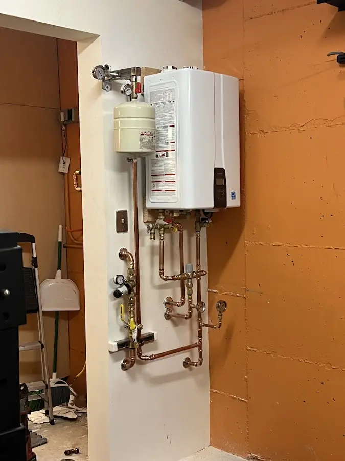 Plumbing technician inspecting water heater connections in Paducah